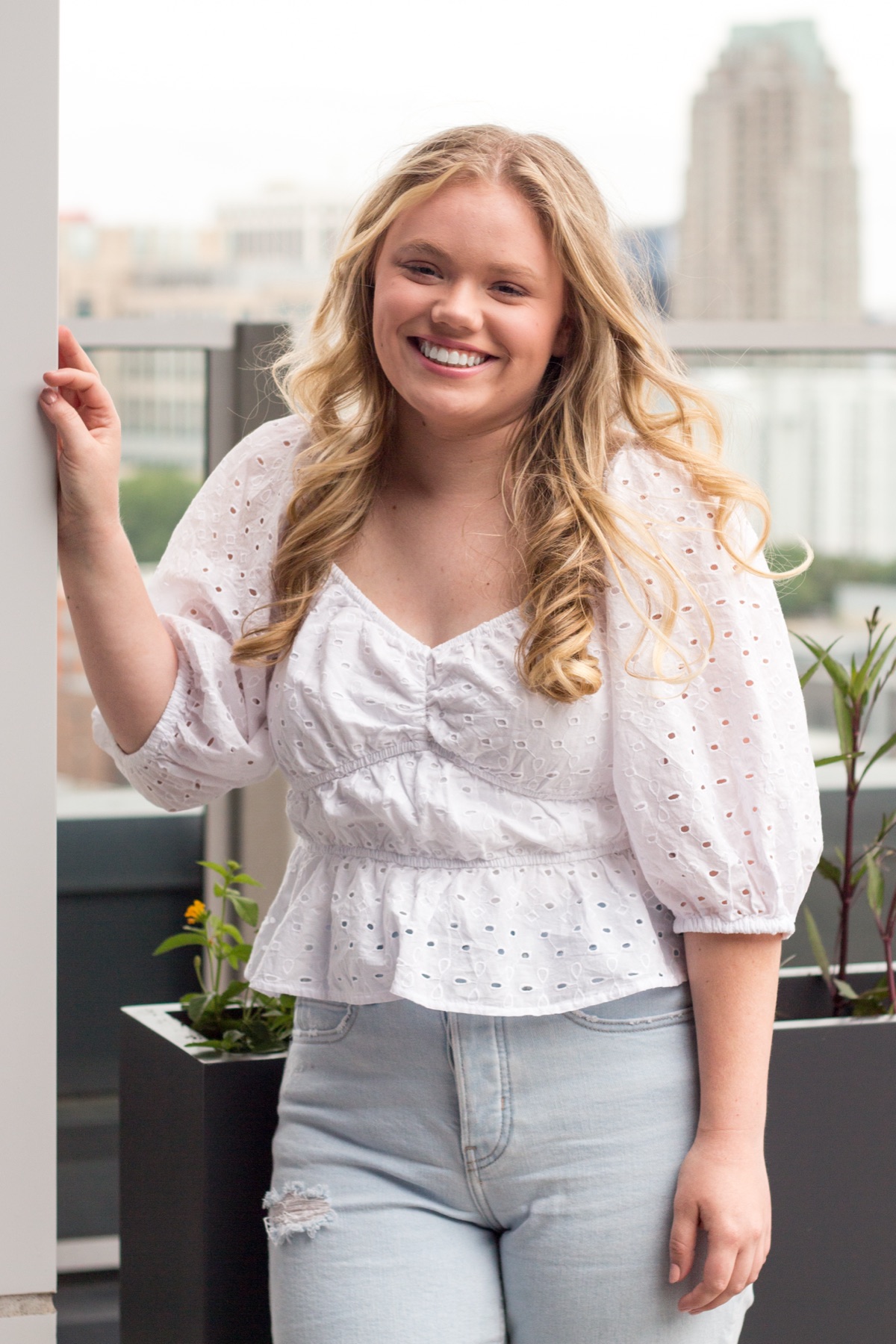 Senior portrait of a young woman on a city rooftop